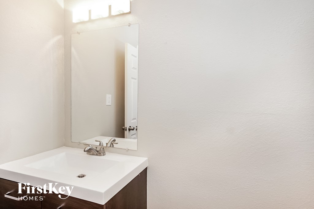 a small bathroom with a sink and a mirror