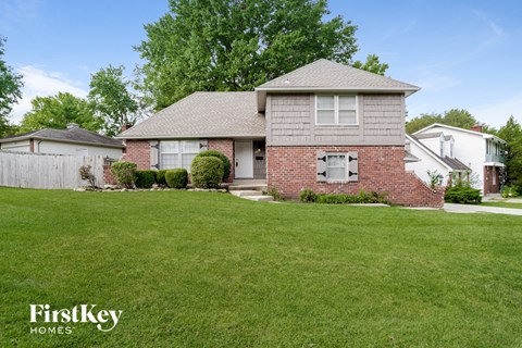 A house with a lawn in front of it.