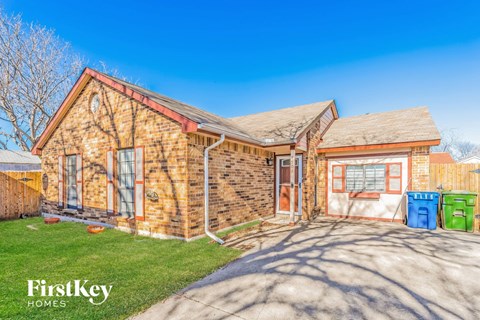 a brick house with a garage and a driveway