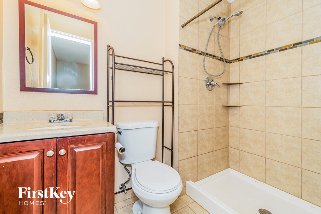 a bathroom with a shower toilet and a sink