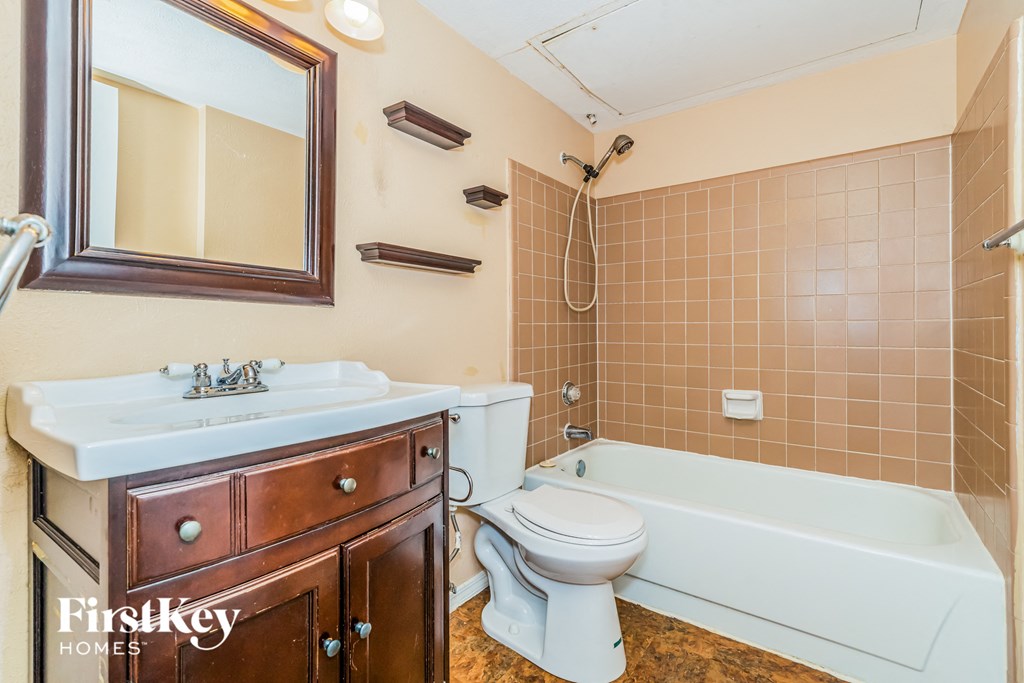 a bathroom with a sink toilet and a bath tub