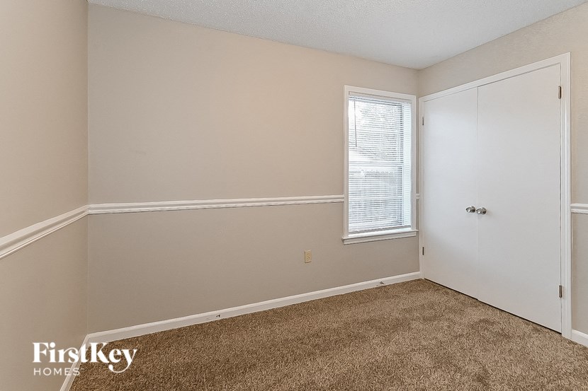 a bedroom with a closet and a window