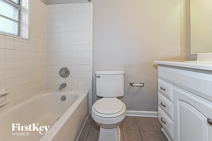 a bathroom with a tub and a toilet and a sink