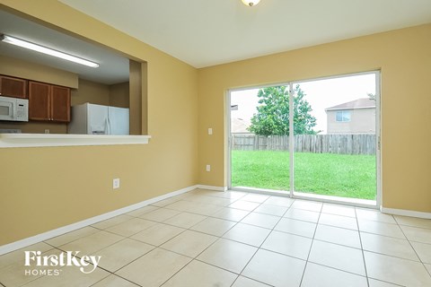 A kitchen area with a refrigerator and microwave.