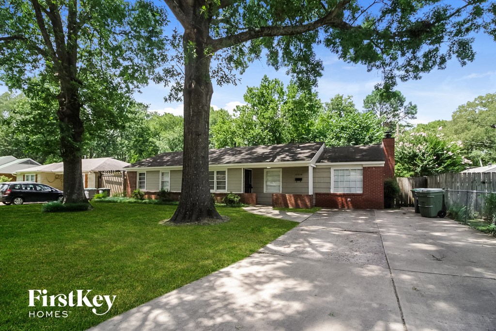 A house with a tree in front of it.