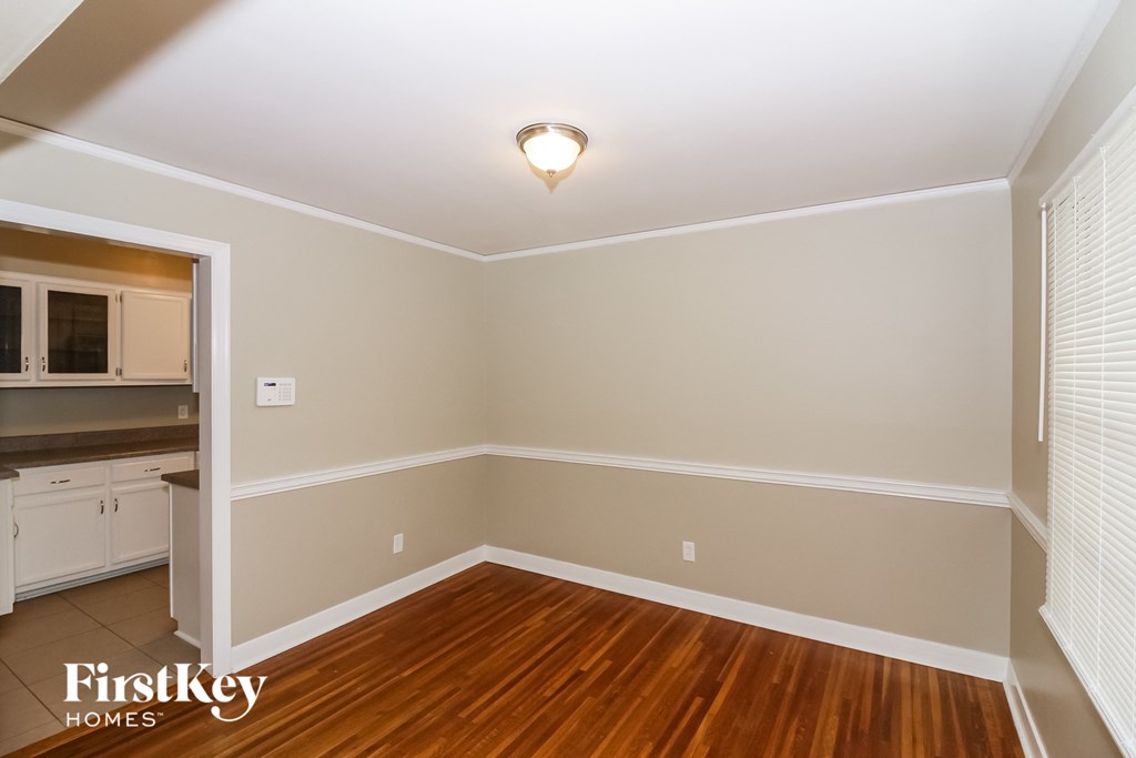 A room with wooden floors and white walls.