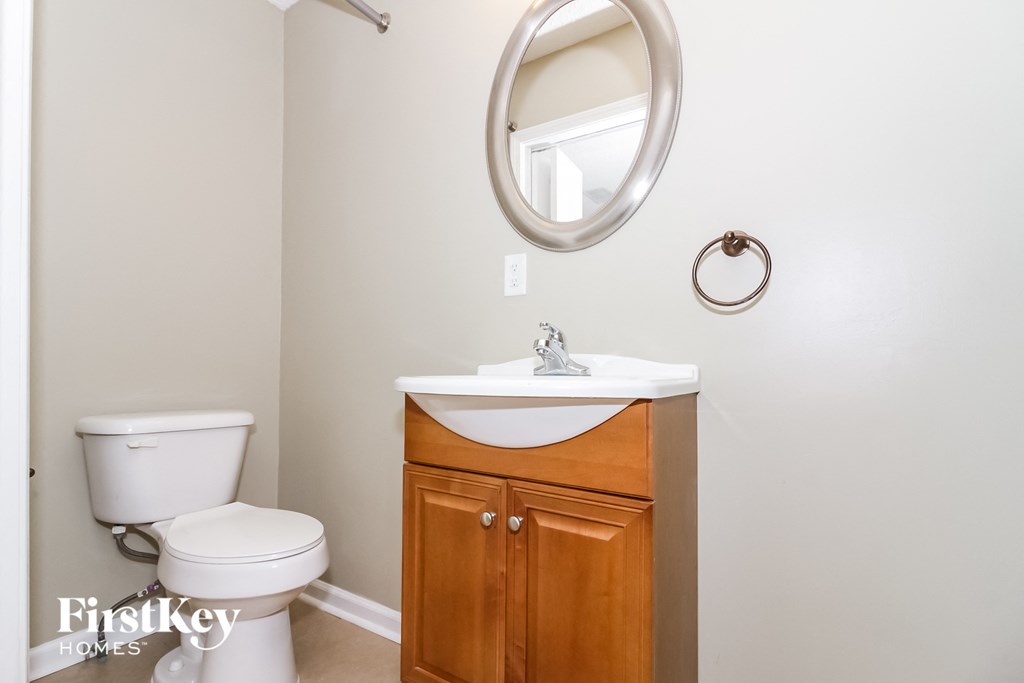 A white toilet sits next to a sink in a small bathroom.