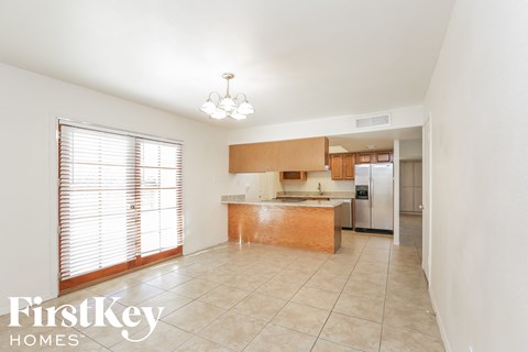 a kitchen with a large window and a sink and a refrigerator