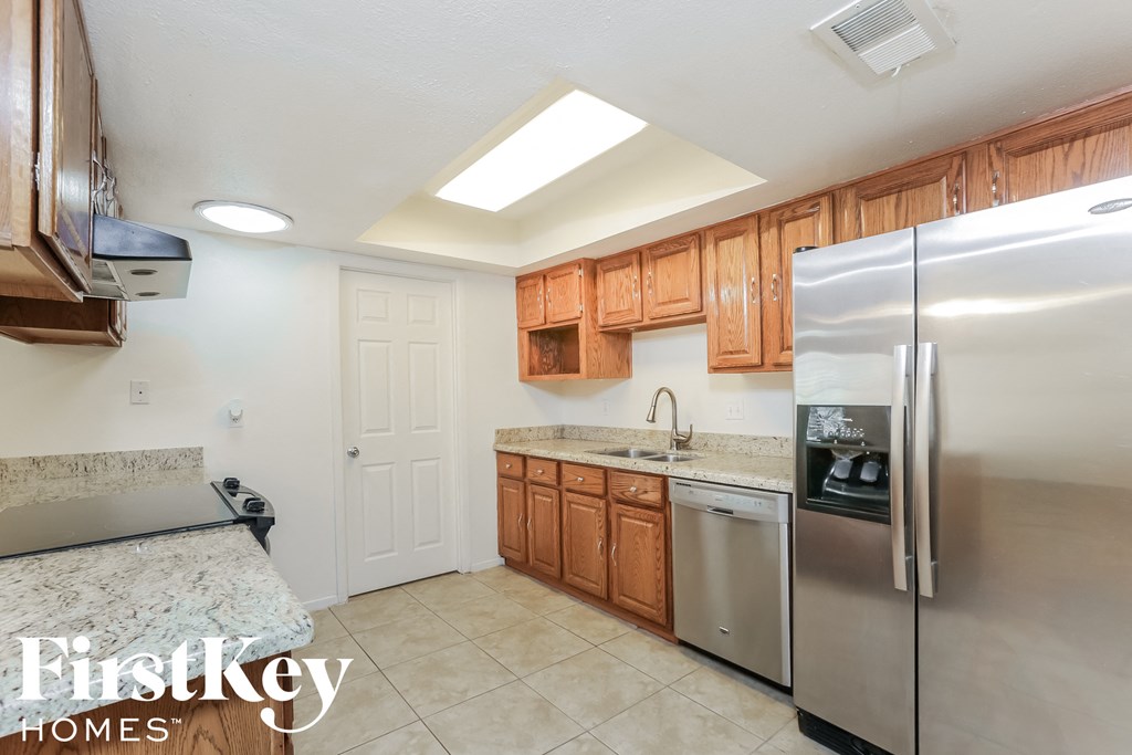 a kitchen with stainless steel appliances and wooden cabinets