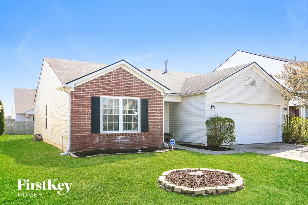 A house with a brick front and a white garage door.
