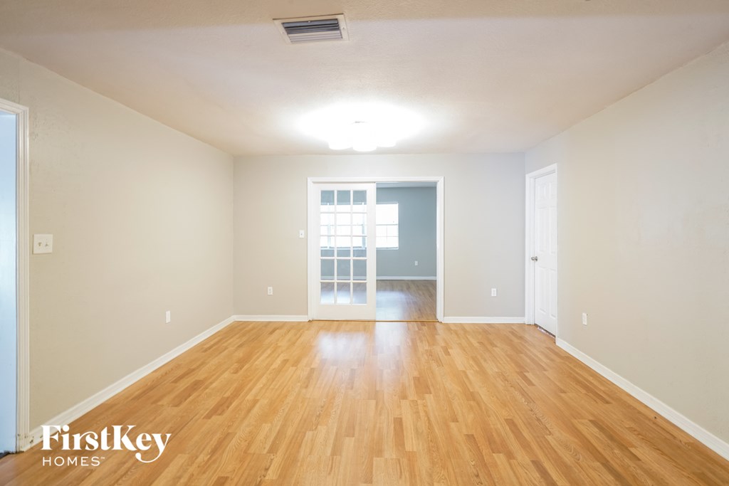 A room with wooden floors and a large window.