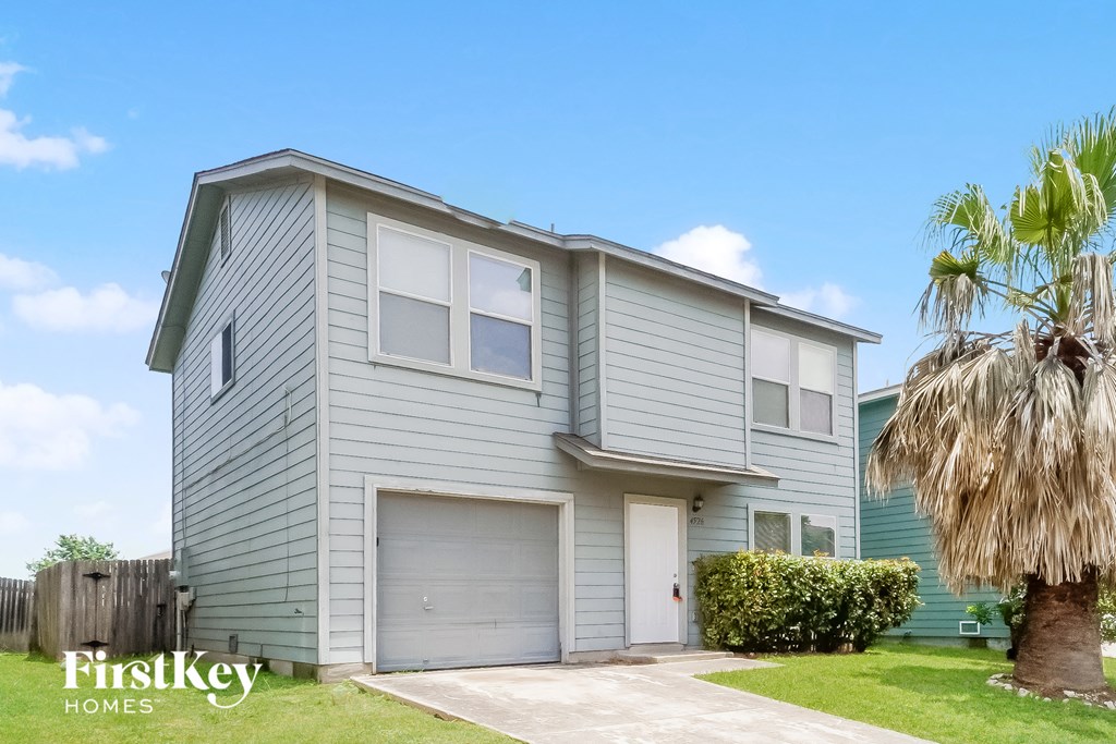 a blue house with a palm tree in front of it