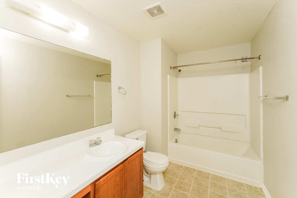 a bathroom with a sink toilet and a shower