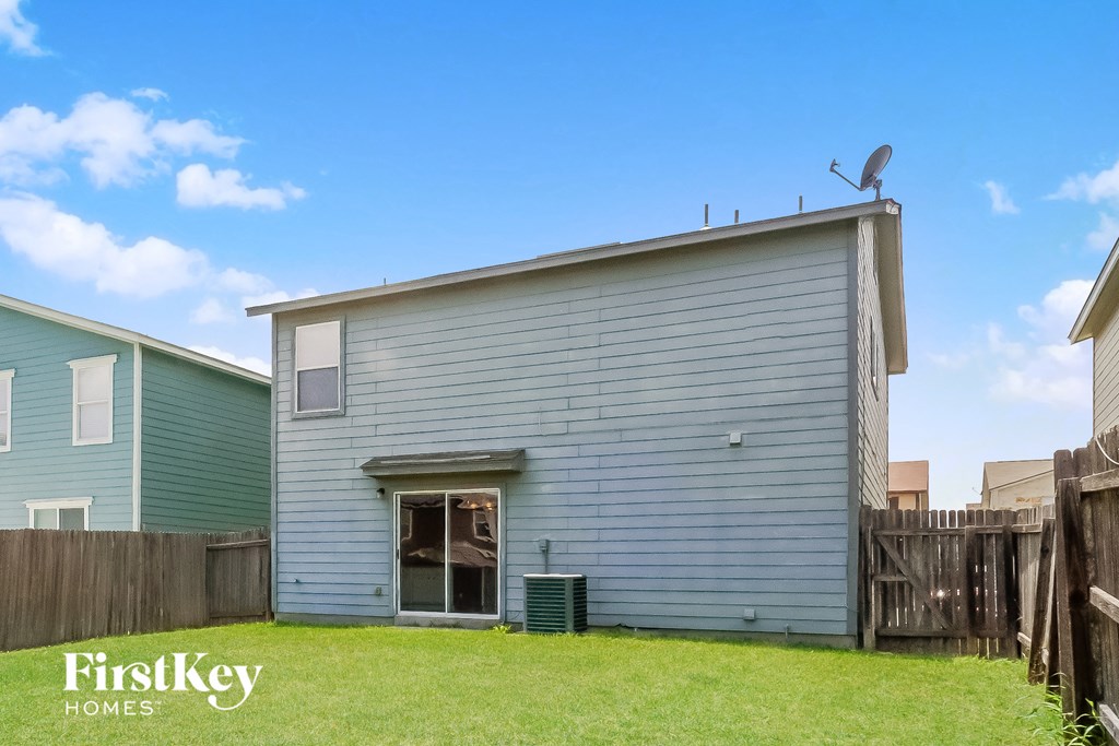 a blue house with a satellite dish on top of it