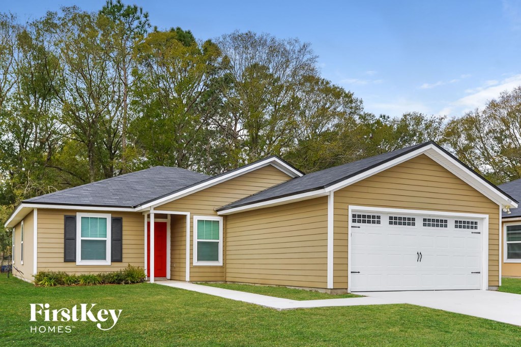 a home with a garage and a lawn