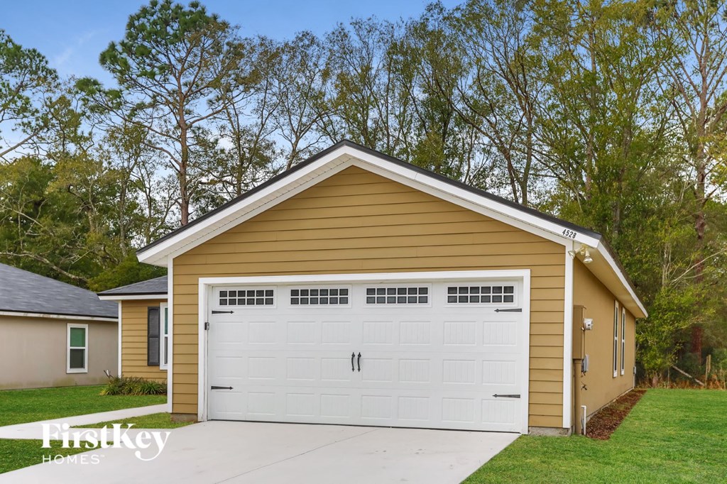 the front of a garage with a white garage door
