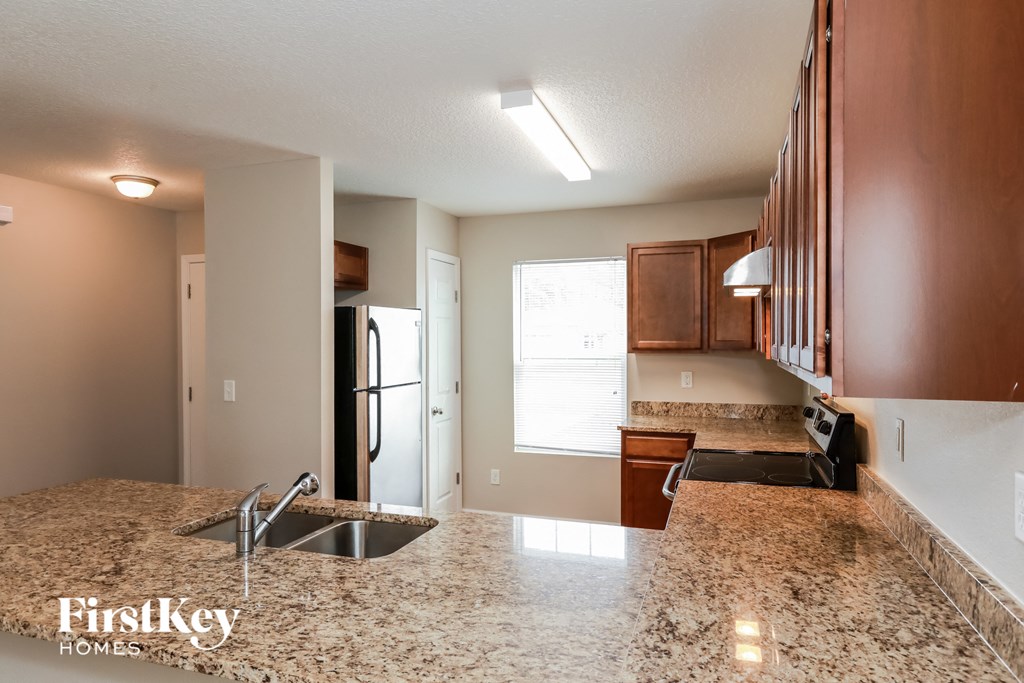 a kitchen with a sink and a refrigerator