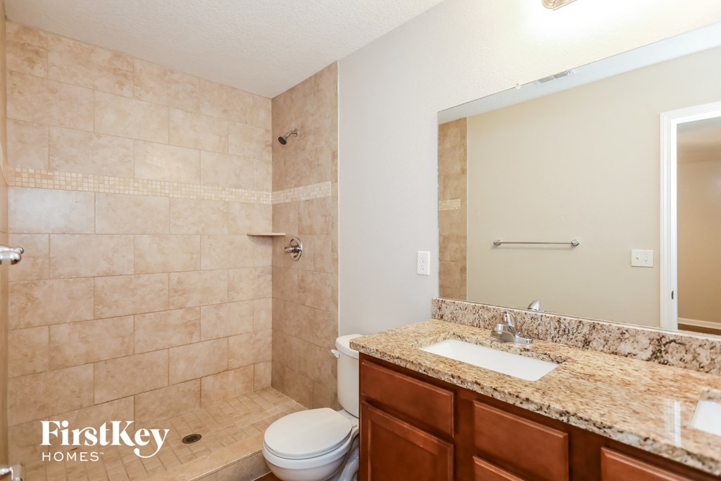 a bathroom with a toilet and a sink and a mirror