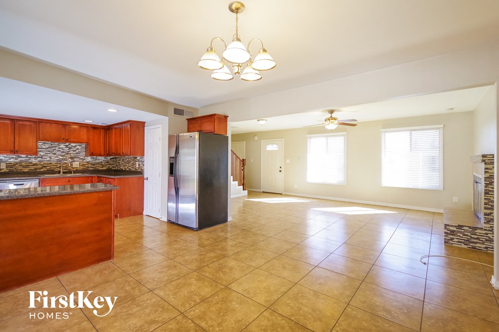 a large kitchen with a stainless steel refrigerator and a counter top