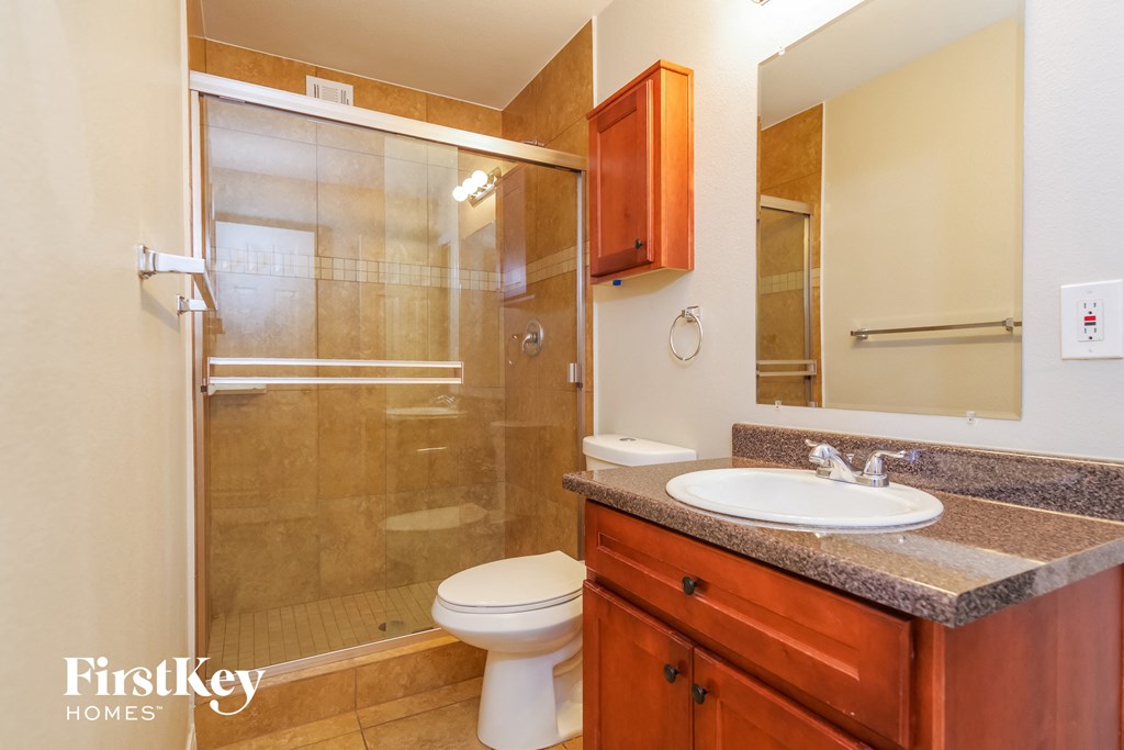a bathroom with a shower toilet and sink