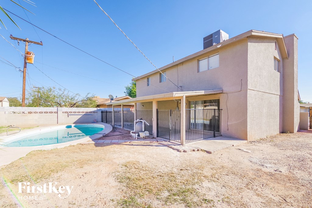 a house with a pool and a boat in front of it
