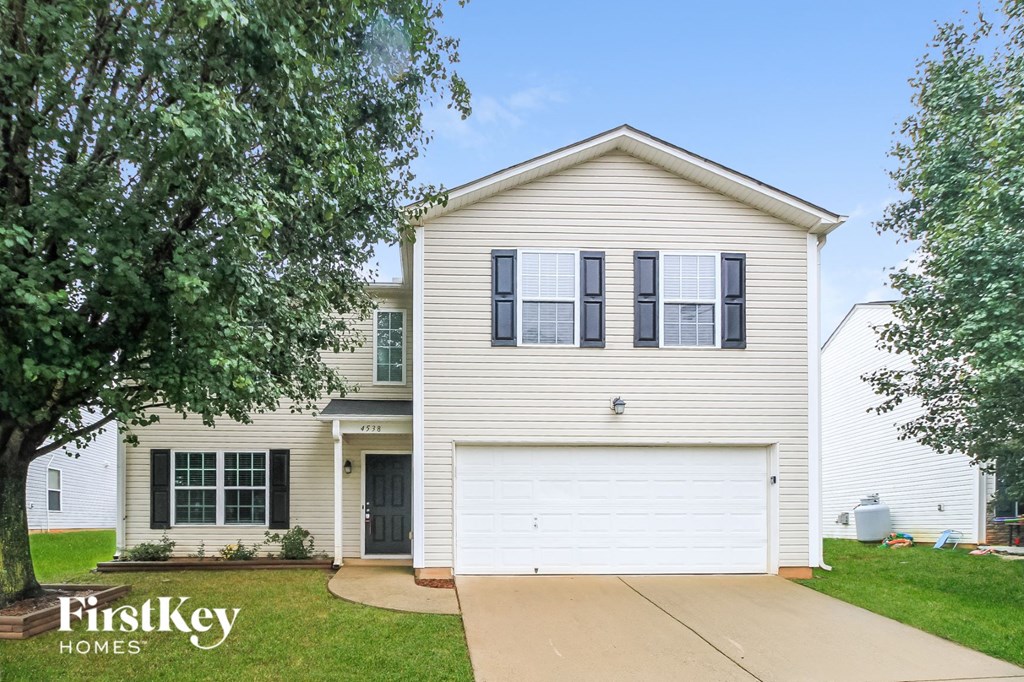 a white house with a white garage door