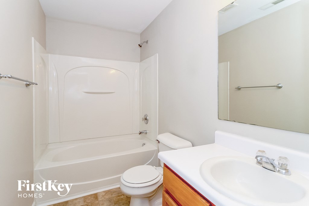 a bathroom with a sink toilet and a tub