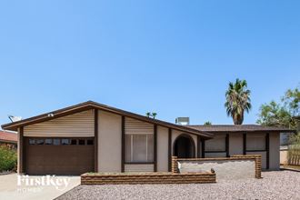 a home with a garage and a palm tree
