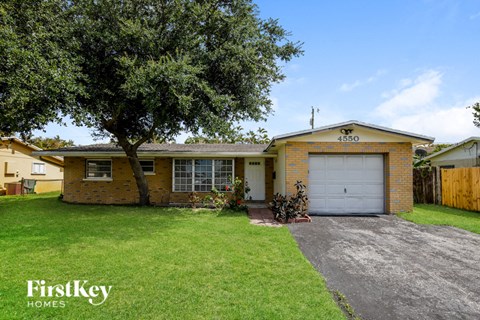 a yellow brick house with a white garage door