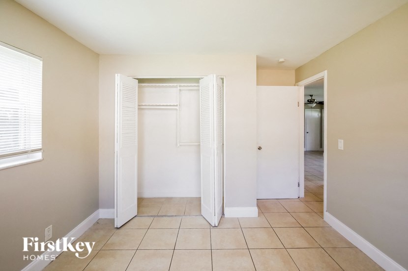 a walk in closet with two closets and a tiled floor in a room