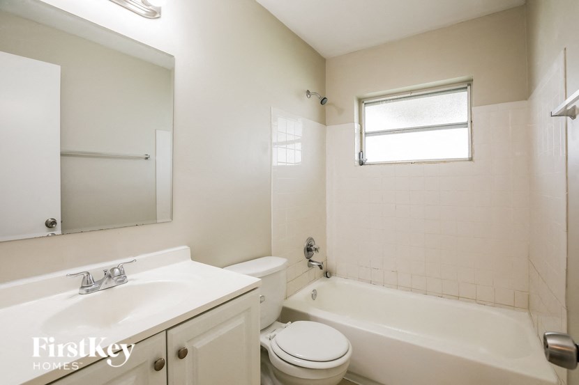 a white bathroom with a sink toilet and tub