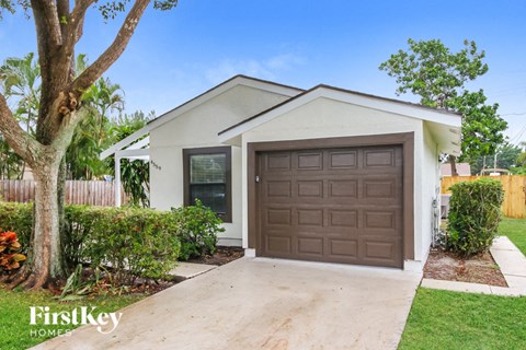 A house with a brown garage door is for sale.