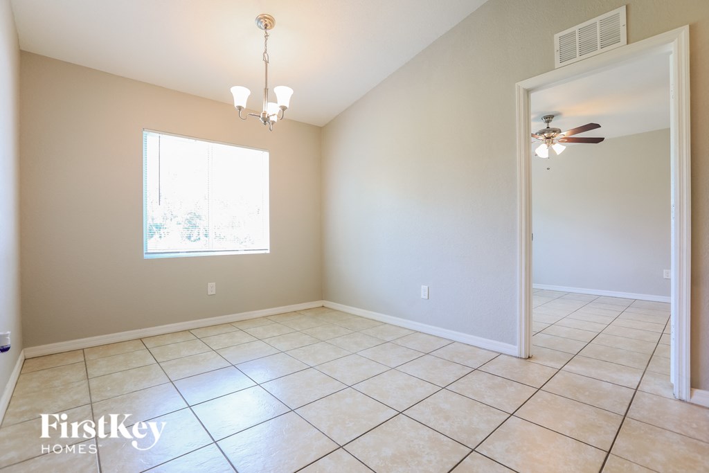 A room with a ceiling fan and a window.