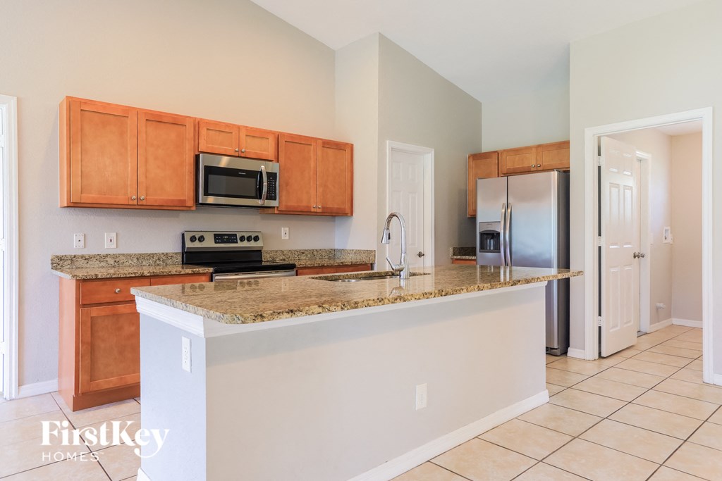 A kitchen with a counter top and a refrigerator.