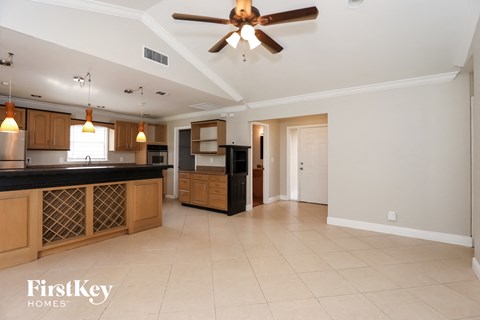 A kitchen with a fan and a counter top.