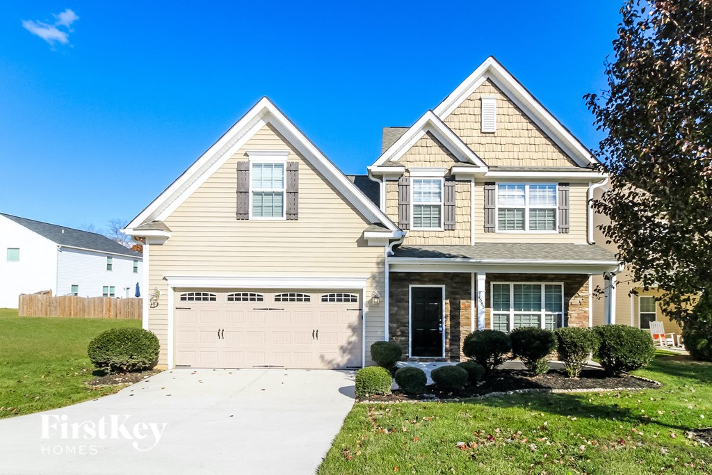 a yellow house with a white garage door