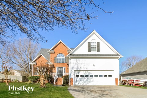 a house with a white garage door and a blue sky