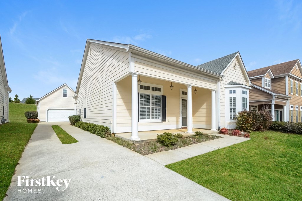 A house with a white garage door and a driveway in front.