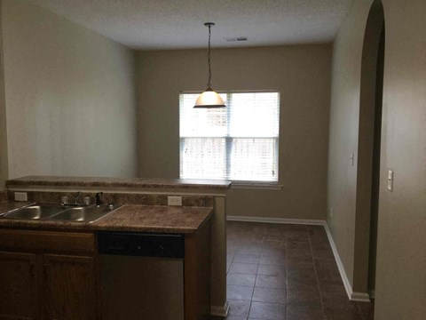 A kitchen with a sink and a window.