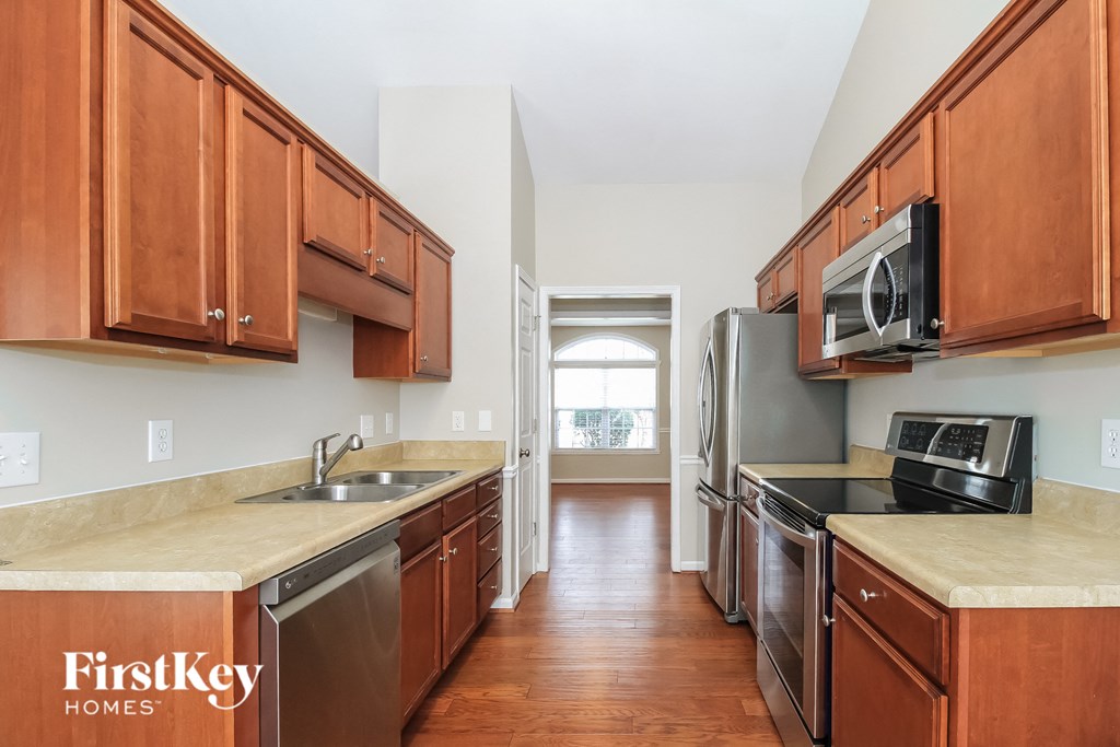 a kitchen with wooden cabinets and stainless steel appliances