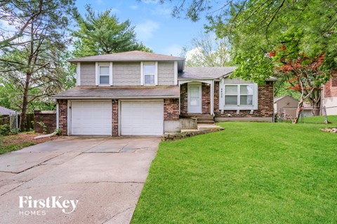 A house with a garage and a driveway is for sale.