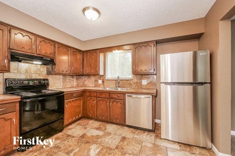 a kitchen with stainless steel appliances and wooden cabinets