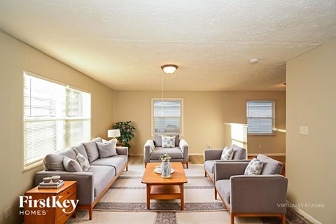 A living room with a grey couch and a coffee table.