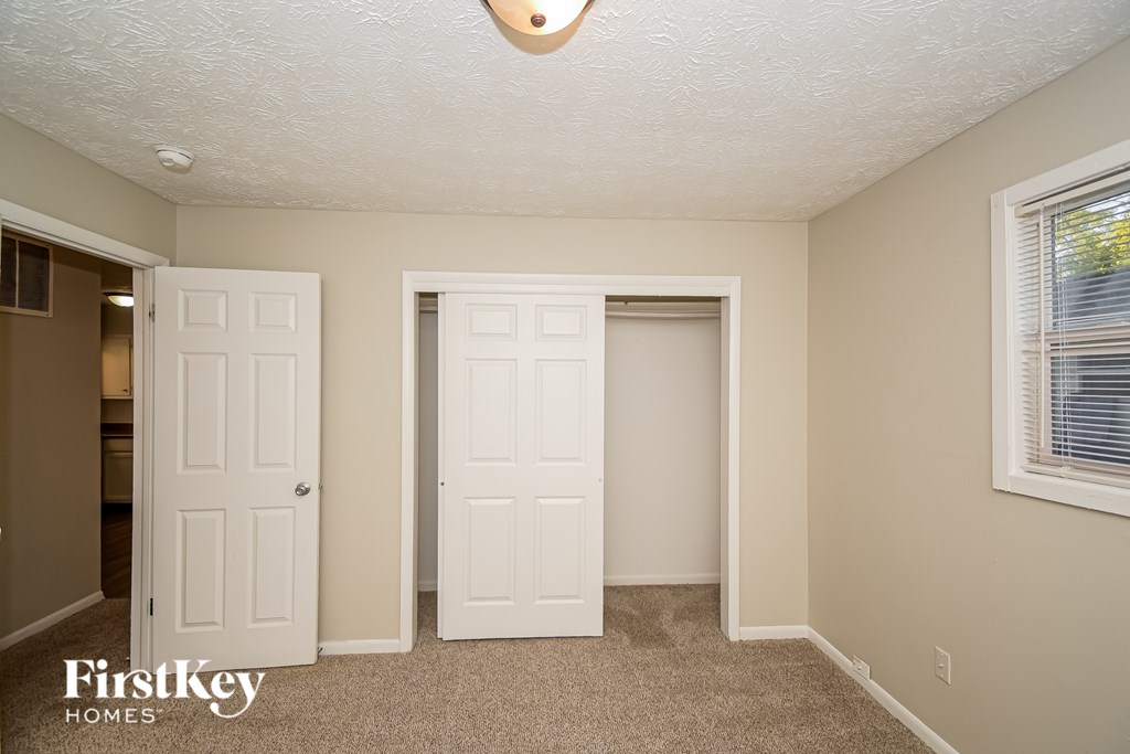 A room with two doors and a window.