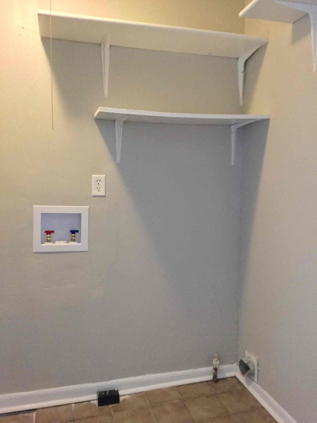 a closet with a shelf on the wall