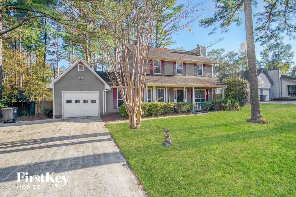 a house with a driveway and a white garage door
