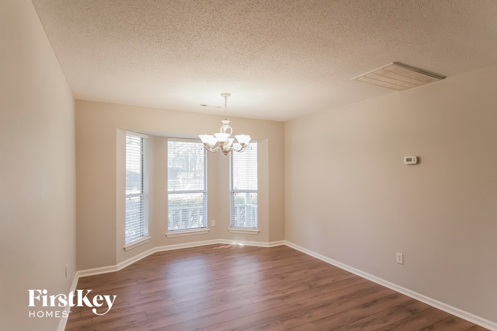 a living room with wood floors and a large window