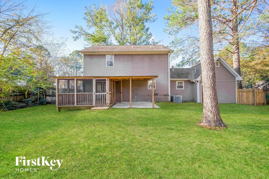 a backyard with a screened porch and a house
