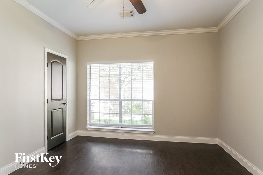 an empty living room with a window and a door