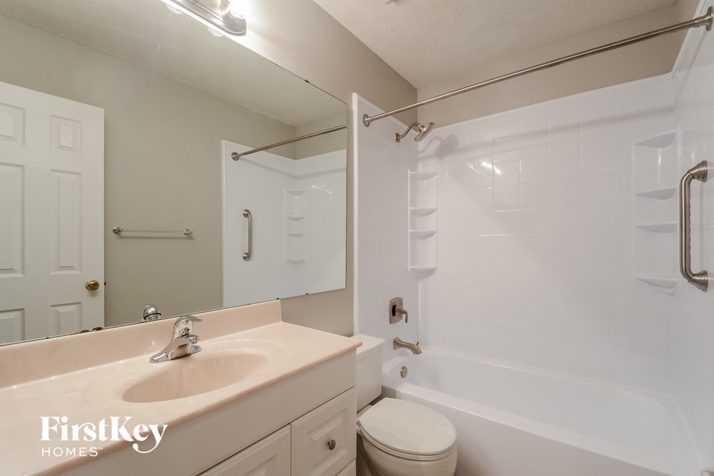 a bathroom with a sink and a shower and a toilet